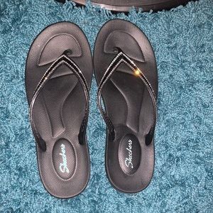 Black bedazzled sketchers flip flops